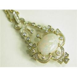 An 18ct gold pendant set with an opal cabochon of approx 16 x 12mm and 34 round brilliant cut...