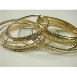 Twelve various bangles, including a 9ct Victorian hinged bangle set with turquoise and seed pe...