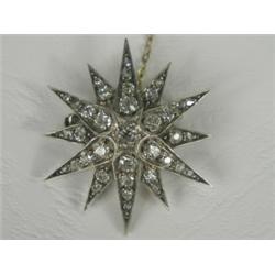 A Victorian diamond star brooch set with old cut stones, 3.5cm in diameter, with a safety chai...