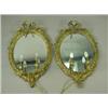 Image 1 : A pair of late 19th Century oval wall mirrors, the gilded gesso frames with ribbons and flower...