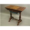 Image 1 : A Victorian rosewood games/worktable, the sliding top enclosing a backgammon board with a gilt...