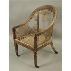 A Regency period mahogany framed bergere chair, with turned and leaf carved front legs, (canin...