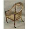 Image 1 : A Regency period mahogany framed bergere chair, with turned and leaf carved front legs, (canin...