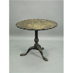 A mahogany tripod table, the one piece top with an applied carved Chippendale shaped border on...