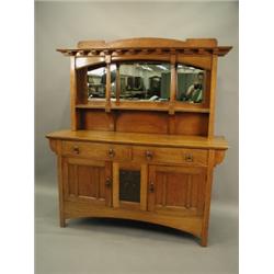 A Waring & Gillows oak Art Nouveau mirror back sideboard, the base inset with an embossed copp...