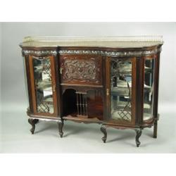 A late 19th Century display cabinet with brass gallery rail, above carved foliate frieze with...