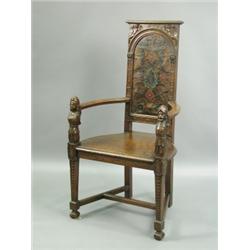 A late 19th Century carved oak armchair, with a painted and embossed leather back with figural...