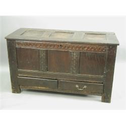 An early 18th Century oak mule chest with a three panel front, top and rear, and hand carved a...