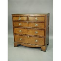 An early 19th Century northern counties style oak chest of drawers crossbanded in mahogany, wi...