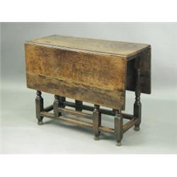 An 18th Century and later oak gate leg table, the turned legs joined by plain stretches. (Late...