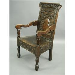 An 18th Century and later oak Wainscot chair, period and later carved decoration. 102.5cm high...
