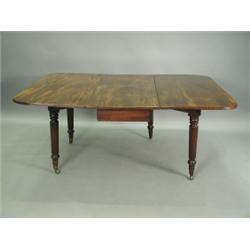 A George III mahogany drop leaf dining table supported upon Gillows style reeded legs with bra...