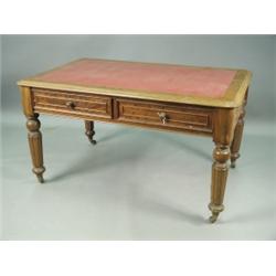 A Victorian mahogany library table, with a leather top, two frieze drawers on turned tapering...
