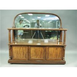 A Victorian mahogany mirror back buffet, with two open tiers, the base enclosing three cupboar...