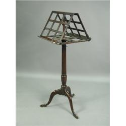 A George III mahogany music stand, the double sided adjustable top with lattice panels and hin...