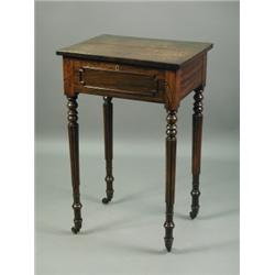 A mid 19th Century rosewood lamp table, with a single drawer, raised on turned and reeded legs...