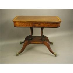 An early 19th Century mahogany tea table, the folding top with rosewood and satinwood cross ba...
