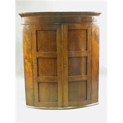 A 19th Century mahogany bowfront hanging corner cupboard, 129.5cm high Est. 300/500...