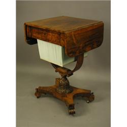 A Regency rosewood worktable, the top with rounded edge drop flaps, over a sewing drawer and w...