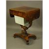Image 1 : A Regency rosewood worktable, the top with rounded edge drop flaps, over a sewing drawer and w...
