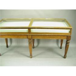 A Victorian mahogany double table display cabinet, with a slanted top on turned legs, 230cm wi...