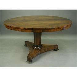 A Victorian rosewood circular top centre table, on an octagonal tapering column, a triform bas...