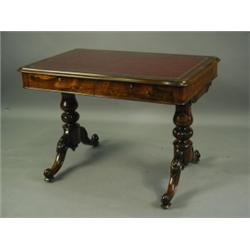 A Victorian rosewood library table with a leather inset over two frieze drawers and turned and...