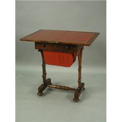 A William IV mahogany work table with a fold over top, frieze drawer and work basket on carved...