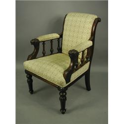 A Victorian walnut armchair, with an upholstered back, arms and seat, the arms with spindles a...
