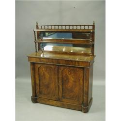 A Victorian rosewood and walnut chiffonier with two mirror backed tiers, over panelled doors,...