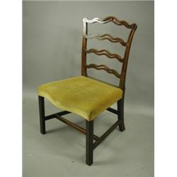 An 18th Century mahogany ladderback chair with pierced wavy bars, over a serpentine fronted se...