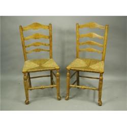 A pair of early 19th Century ladder back chairs with rush seats Est. 200/300...
