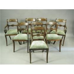 A set of eight Regency mahogany and brass strung bar back dining chairs with carved central ra...
