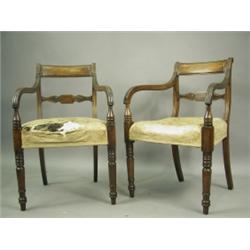 A pair of George III mahogany elbow chairs, each with a moulded rectangular top rail over a ta...
