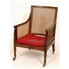 Image 1 : An Early 19th Century Mahogany Bergere Armchair, with single cane back and sides, on tapering tur...