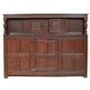 Image 1 : An Oak Court Cupboard, the upper section having a pair of carved panel doors, flanked by a furthe...