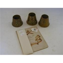 THREE TRENCH ART TAPERED VESSELS, applied insignia and a 1918 Machine Gun Corps booklet (4)  20-3...