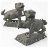 Image 1 : A pair of Chinese bronze lion dog candlesticks, on pierced foliate stands....