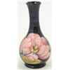 Image 1 : A Moorcroft Magnolia vase of globe and shaft form, the design against a dark blue ground, 6in....
