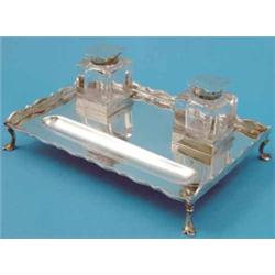 An Edwardian silver inkstand, of rectangular form with two glass wells, 8.5ins, 1909 11oz...