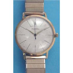 A gentlemans gold Movado wrist watch, with circular case and baton numerals....