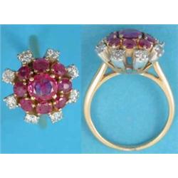 A ruby and diamond flowerhead cluster ring claw set in yellow metal....