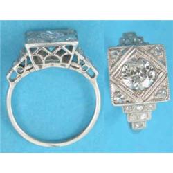 A platinum and diamond ring, the square bezel millegrain set with a central old brilliant cut dia...