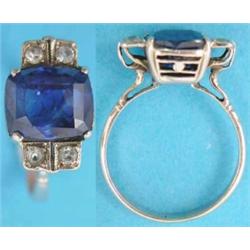 A gold ring claw-set with a Ceylon sapphire, the cornflower blue cushion shape stone approx. 5cts...