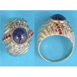 A gold bombe shape dress ring set with a central cabochon sapphire and round cut diamonds and rub...