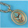 Image 1 : A Victorian gold and blue enamel oval pendant locket with foliate engraved decoration, the front...