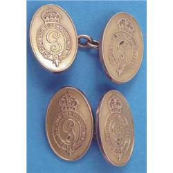 A pair of gold oval cufflinks with chain link connections and "Honi soit qui mal y pense" cipher,...