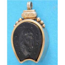 A late Victorian 9ct. gold horseshoe shape fob compass, the reverse with an intaglio carved horse...