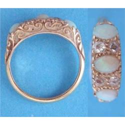 An Edwardian 18ct. gold opal and diamond half hoop ring....