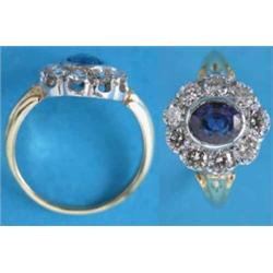An 18ct. gold sapphire and diamond oval cluster ring....